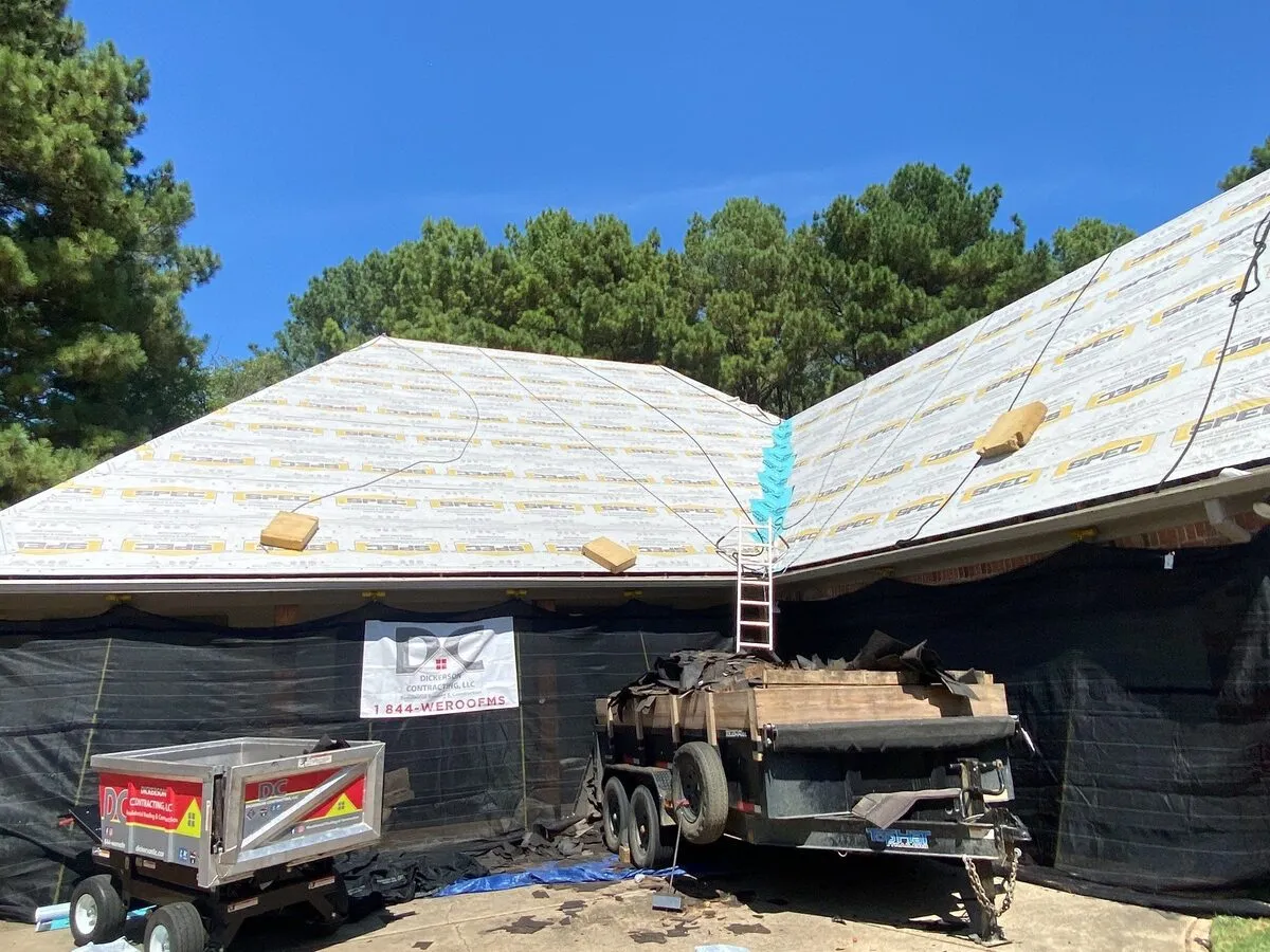 Roof dried in with the Dickerson Contracting banner on a job site