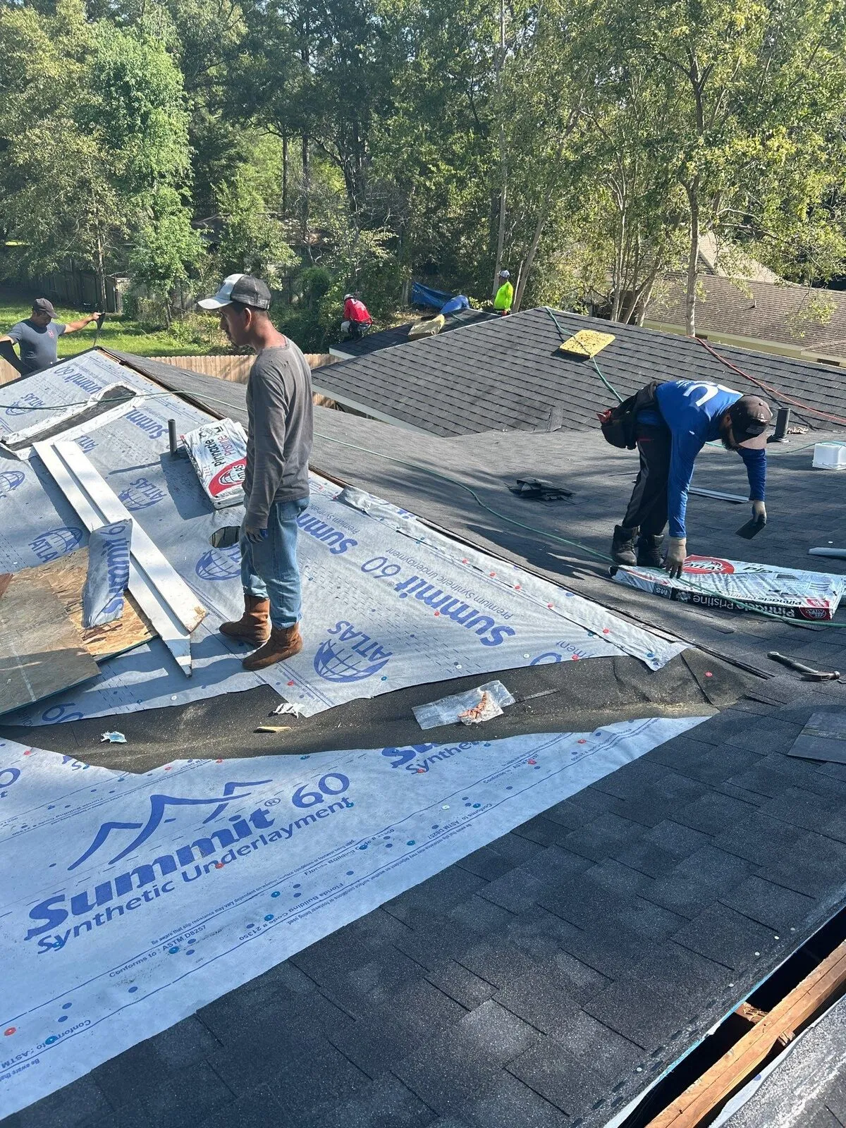 Dickerson crew working across underlayment with edge metal staged