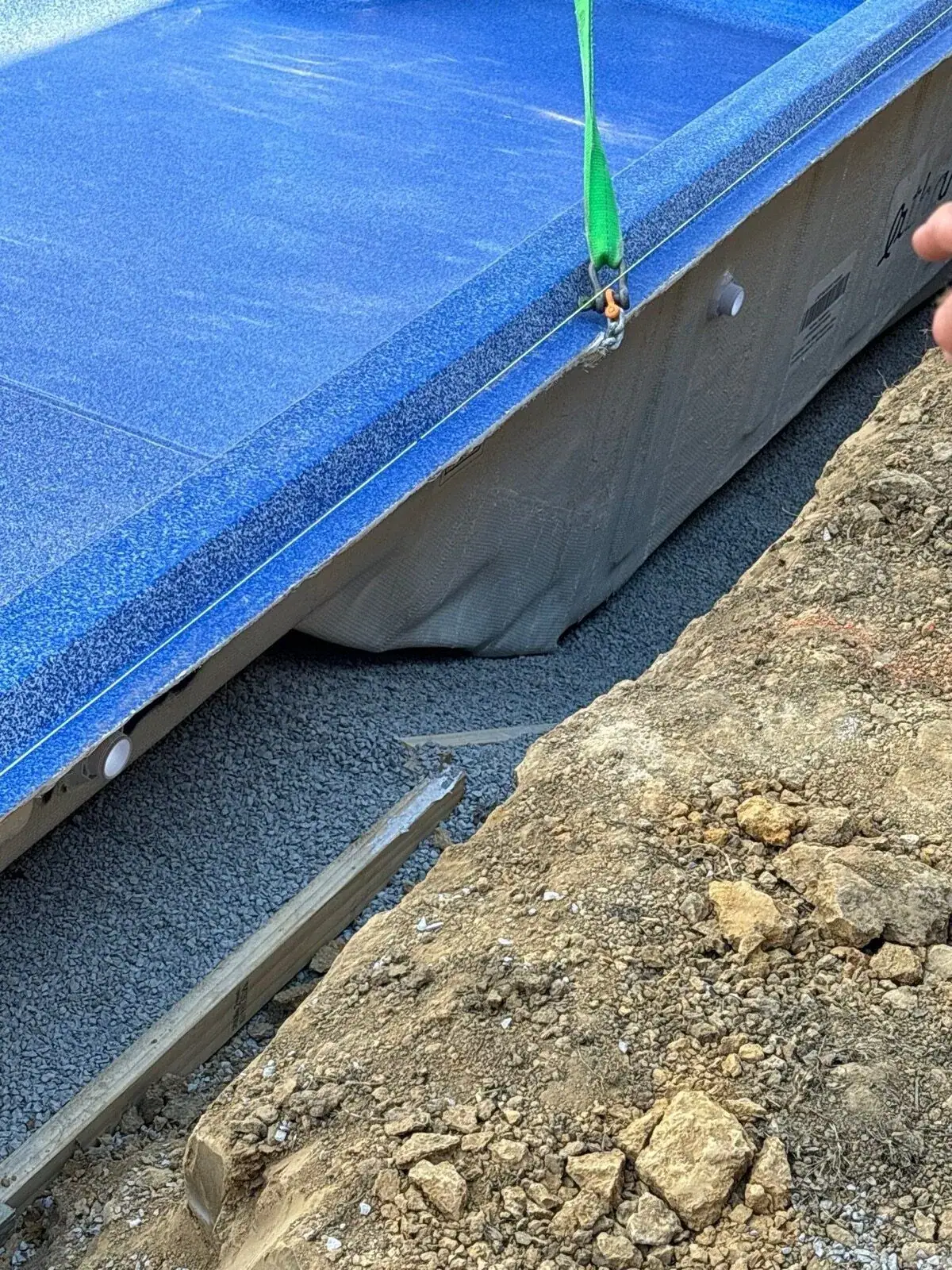Crane setting a Latham fiberglass shell on a DC Pools jobsite