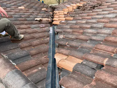 Roof repair work on a shingle field